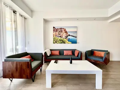 a living room with two couches and a table at C066-Luxurious apartment with sea view - Cannes in Cannes