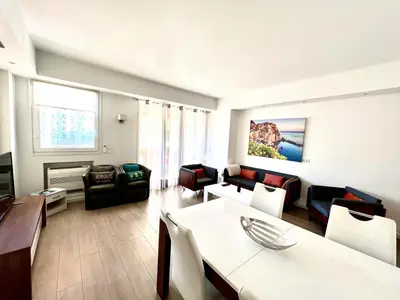 a living room with a couch and a table and chairs at C066-Luxurious apartment with sea view - Cannes in Cannes