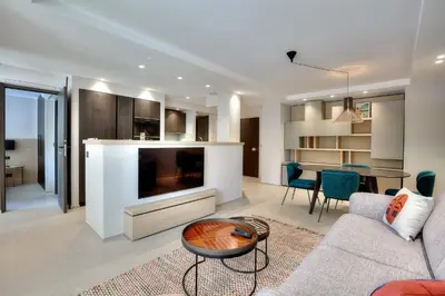 a living room with a couch and a table at Luxury flat with balcony - city center Cannes in Cannes