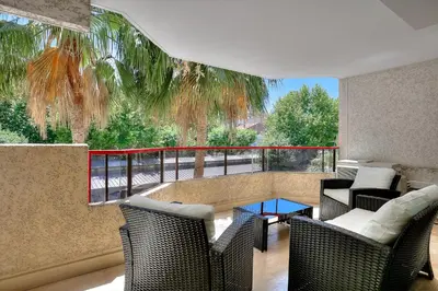 a balcony with chairs and a table with a view at Luxury flat with balcony - city center Cannes in Cannes