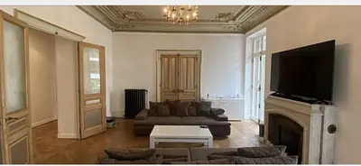 a living room with a couch and a fireplace at Croisette Palais festival 5 minutes , 170 m2 moderne spacious in Cannes