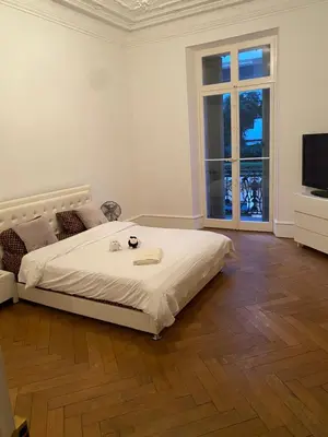 a white bedroom with a bed and a television at Croisette Palais festival 5 minutes , 170 m2 moderne spacious in Cannes
