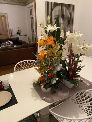 a table with two vases filled with flowers on it at Croisette Palais festival 5 minutes , 170 m2 moderne spacious in Cannes