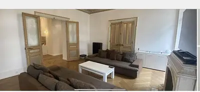 a living room with a couch and a table at Croisette Palais festival 5 minutes , 170 m2 moderne spacious in Cannes