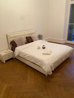 a bedroom with a large bed with a white comforter at Croisette Palais festival 5 minutes , 170 m2 moderne spacious in Cannes