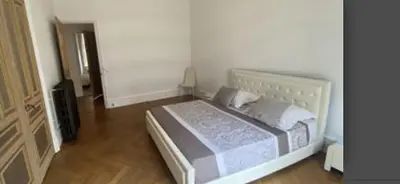 a bedroom with a large bed with a wooden floor at Croisette Palais festival 5 minutes , 170 m2 moderne spacious in Cannes