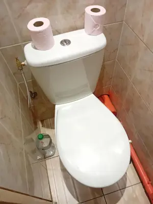 a white toilet with two rolls of toilet paper on it at Private room full furnished in cannes in Cannes