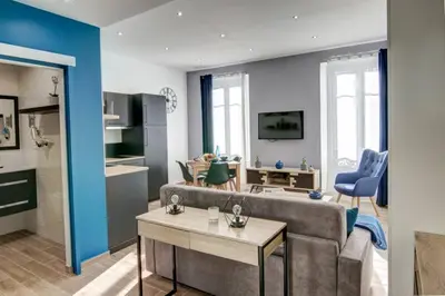 a living room with a couch and a table at Palais Apartment in Cannes