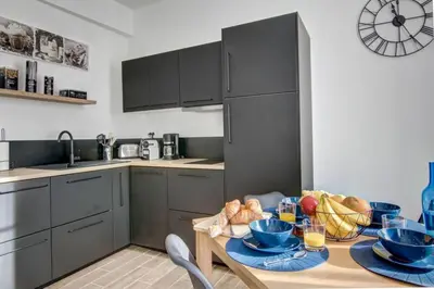 a kitchen with a table with bowls of food on it at Palais Apartment in Cannes