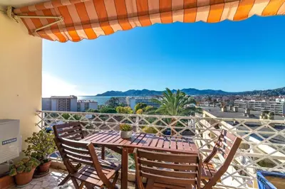 a table and chairs on a balcony with a view at C078-Superb apt in Cannes - Sea view - 6 people in Cannes