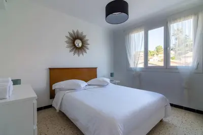 a white bedroom with a white bed and a window at C078-Superb apt in Cannes - Sea view - 6 people in Cannes