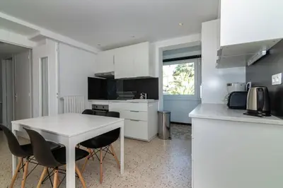 a kitchen with a table and chairs in a room at C078-Superb apt in Cannes - Sea view - 6 people in Cannes