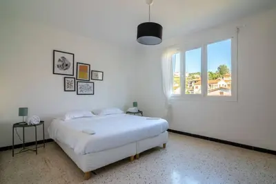 a white bedroom with a bed and a window at C078-Superb apt in Cannes - Sea view - 6 people in Cannes