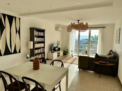 a living room with a table and a couch at C078-Superb apt in Cannes - Sea view - 6 people in Cannes