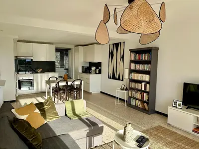 a living room with a couch and a table and a kitchen at C078-Superb apt in Cannes - Sea view - 6 people in Cannes