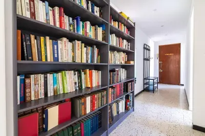 a book shelf filled with books in a hallway at C078-Superb apt in Cannes - Sea view - 6 people in Cannes