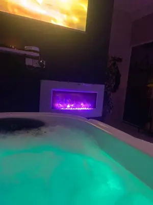 a bath tub with a fireplace in a bathroom at Nuit privée in Cannes