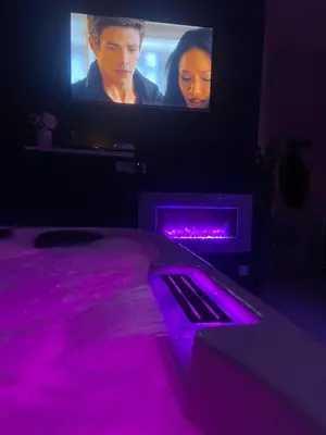 a bedroom with a bed with purple lights at Nuit privée in Cannes