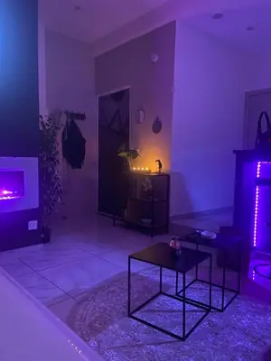 a living room with purple lighting and a table at Nuit privée in Cannes