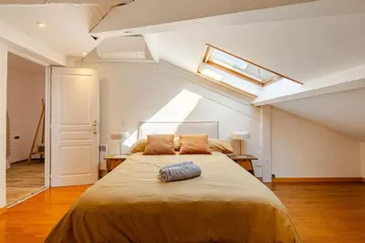 a bedroom with a large bed in an attic at Splendide 80m2 - 2 Chambres - 5,10min Plages & Gare & Palais des Festivals - Air conditionné in Cannes