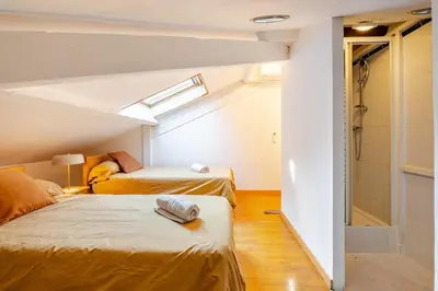 two beds in a small room with a window at Splendide 80m2 - 2 Chambres - 5,10min Plages & Gare & Palais des Festivals - Air conditionné in Cannes