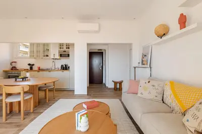 a living room with a couch and a table at Splendide 80m2 - 2 Chambres - 5,10min Plages & Gare & Palais des Festivals - Air conditionné in Cannes