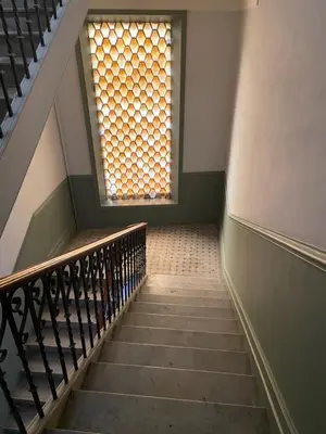 a stairway with a window and a stair case at Splendide 80m2 - 2 Chambres - 5,10min Plages & Gare & Palais des Festivals - Air conditionné in Cannes