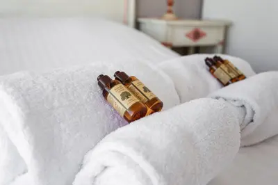 two rolled towels with two bottles of syrup at Le Panoramique Croisette - Welkeys in Cannes