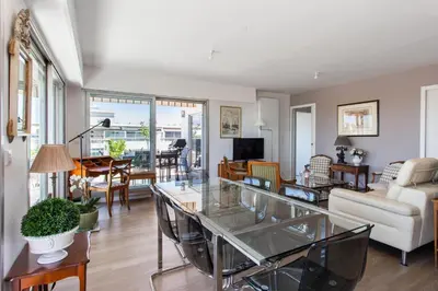 a living room with a glass table at Le Panoramique Croisette - Welkeys in Cannes