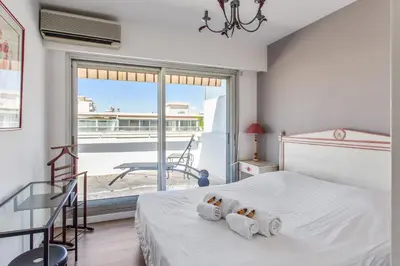 a bedroom with a bed with two teddy bears at Le Panoramique Croisette - Welkeys in Cannes
