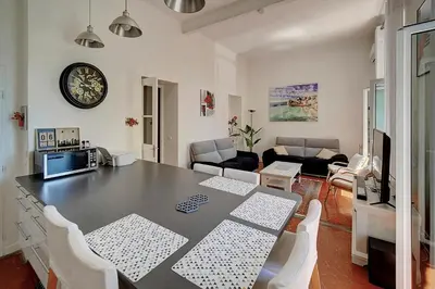 a kitchen and living room with a table and chairs at IMMOGROOM - Fully equipped -AC- near Palais des Festivals in Cannes