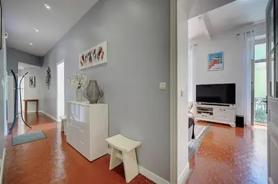 a living room with a flat screen tv and a table at IMMOGROOM - Fully equipped -AC- near Palais des Festivals in Cannes