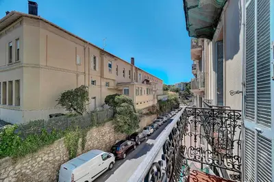 a street with cars parked on the side of a building at IMMOGROOM - Fully equipped -AC- near Palais des Festivals in Cannes