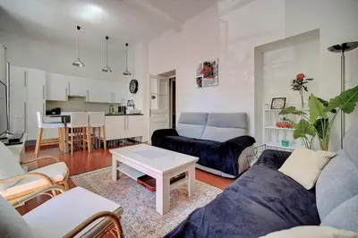 a living room with a couch and a table at IMMOGROOM - Fully equipped -AC- near Palais des Festivals in Cannes
