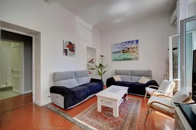 a living room with two couches and a table at IMMOGROOM - Fully equipped -AC- near Palais des Festivals in Cannes