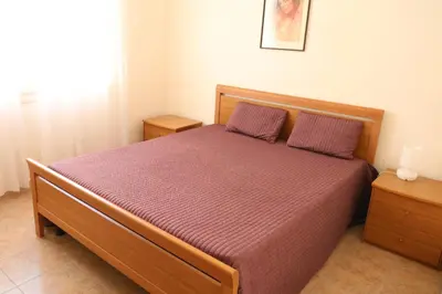 a bedroom with a bed with a purple comforter at 1 Bedroom Henri IV on the Croisette 240 in Cannes