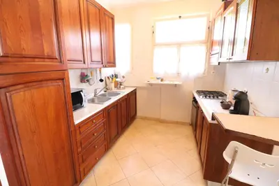 a kitchen with wooden cabinets and a sink at 1 Bedroom Henri IV on the Croisette 240 in Cannes