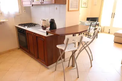 a kitchen with a table and a stove top oven at 1 Bedroom Henri IV on the Croisette 240 in Cannes