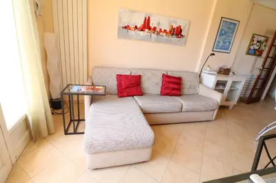 a living room with a couch and red pillows at 1 Bedroom Henri IV on the Croisette 240 in Cannes
