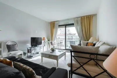 a living room with a couch and a table at Cannes centre 2mins from beach stunning 3-Bed Apt in Cannes