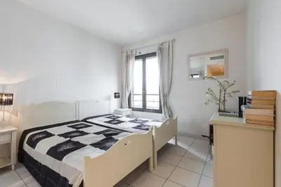 a bedroom with a bed and a desk and a window at Cannes centre 2mins from beach stunning 3-Bed Apt in Cannes