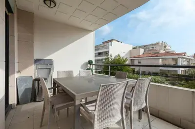 a patio with a table and chairs on a balcony at Cannes centre 2mins from beach stunning 3-Bed Apt in Cannes