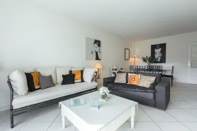 a living room with a couch and a table at Cannes centre 2mins from beach stunning 3-Bed Apt in Cannes