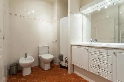 a bathroom with a toilet and a sink and a mirror at Cannes centre 2mins from beach stunning 3-Bed Apt in Cannes