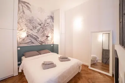 a bedroom with a bed with two towels on it at Diamond Apartment in Cannes