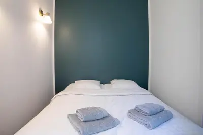 a bedroom with a bed with two towels on it at Diamond Apartment in Cannes