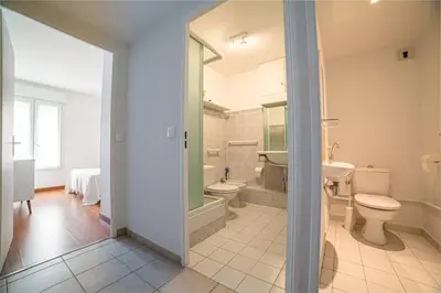 a bathroom with a toilet and a sink at Les Palmiers in Cannes
