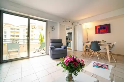 a living room with a couch and a table at Les Palmiers in Cannes