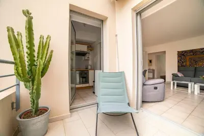 a blue chair and a cactus in a living room at Les Palmiers in Cannes