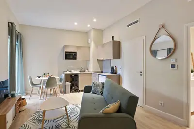 a living room with a couch and a table at Appartement des Anges - Welkeys in Cannes